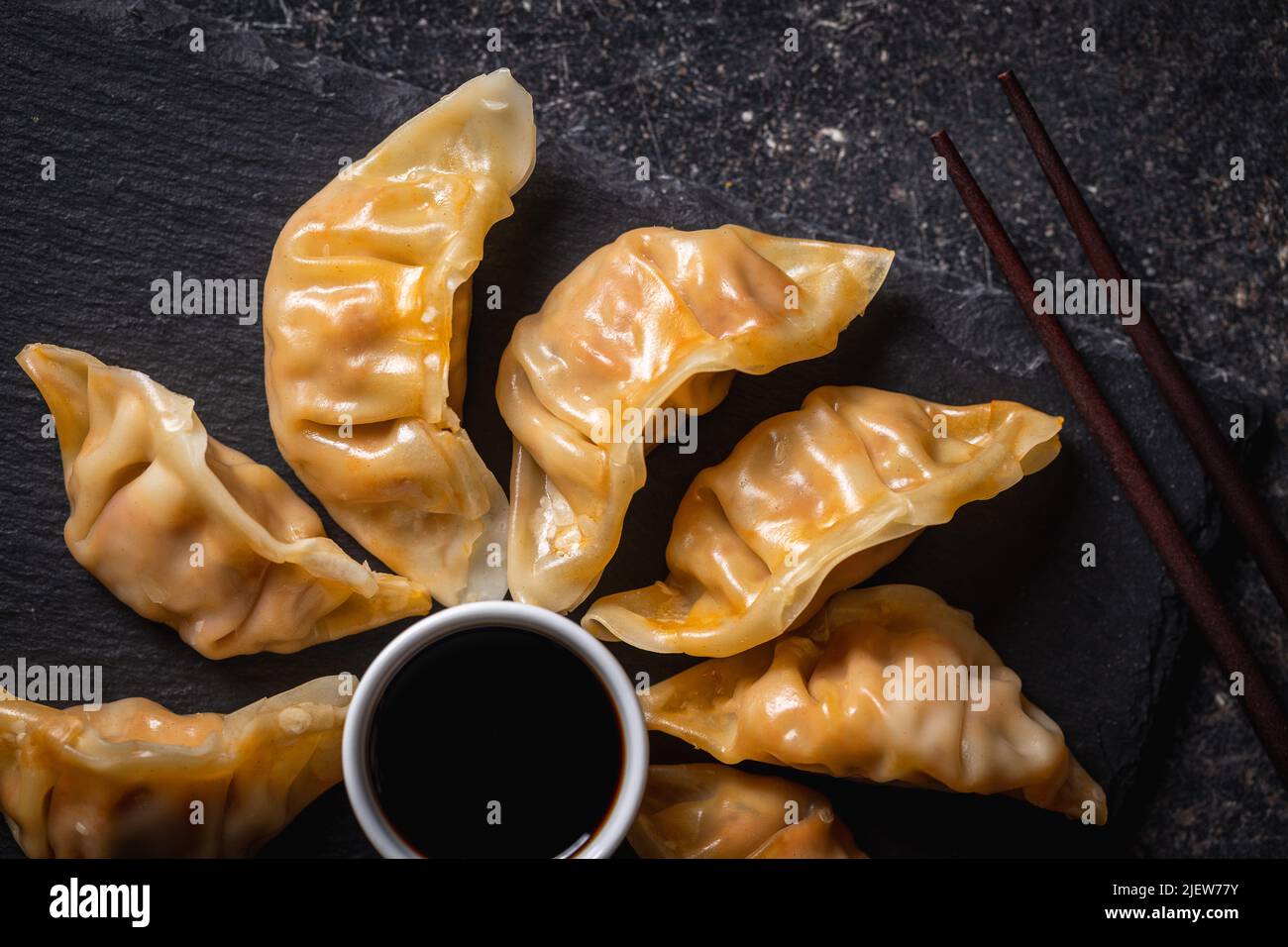 Chinese dumplings abd soy sauce on a cutting board. Top view. Stock Photo
