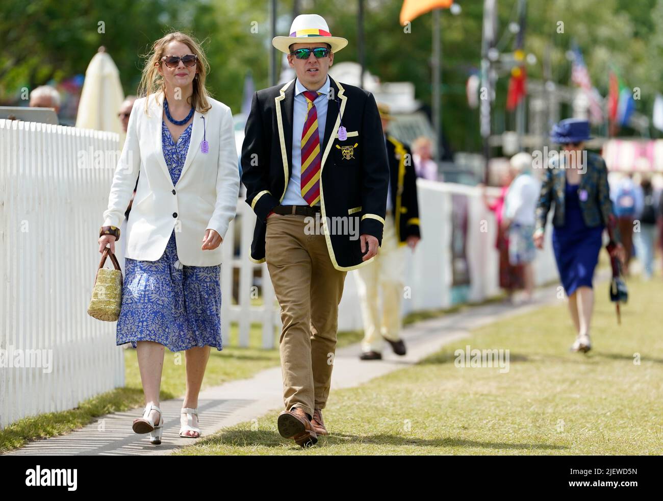 People walk along the river bank on the opening day of the 2022 Henley Royal Regatta alongside the River Thames. Picture date: Tuesday June 28, 2022. Stock Photo