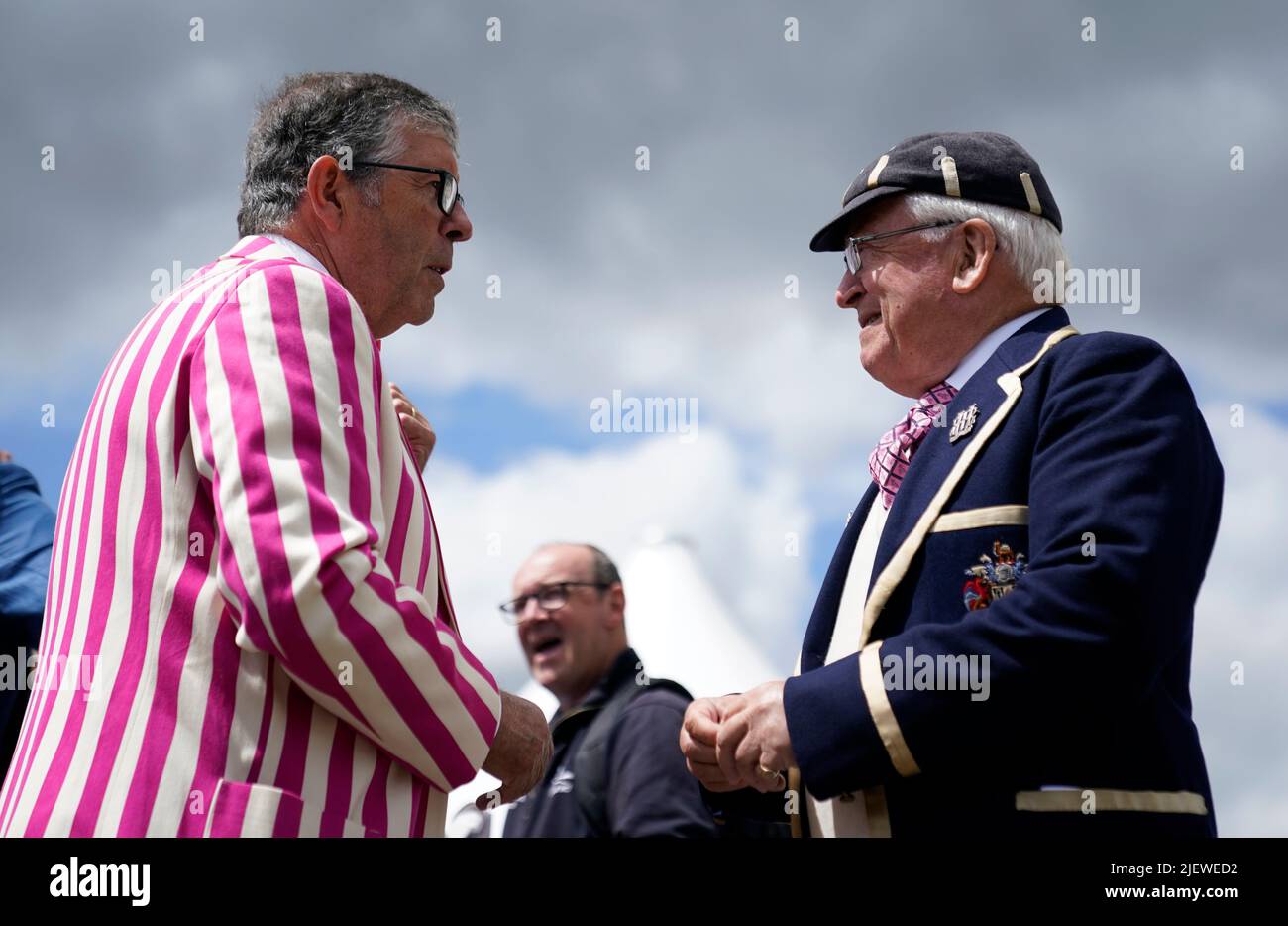 Two people chat as they attend the opening day of the 2022 Henley Royal Regatta alongside the River Thames. Picture date: Tuesday June 28, 2022. Stock Photo