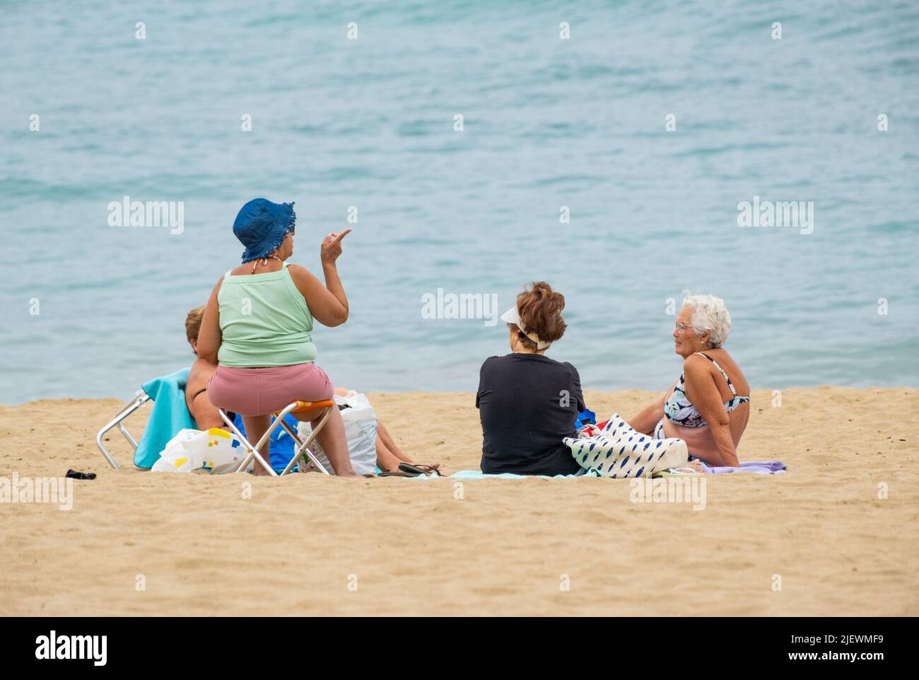 Las Palmas, Gran Canaria, Canary Islands, Spain. 28th June, 2022. Tourists, many from the UK, bask on the city beach in Las Palmas on Gran Canaria. Credit: Alan Dawson/ Alamy Live News. Stock Photo