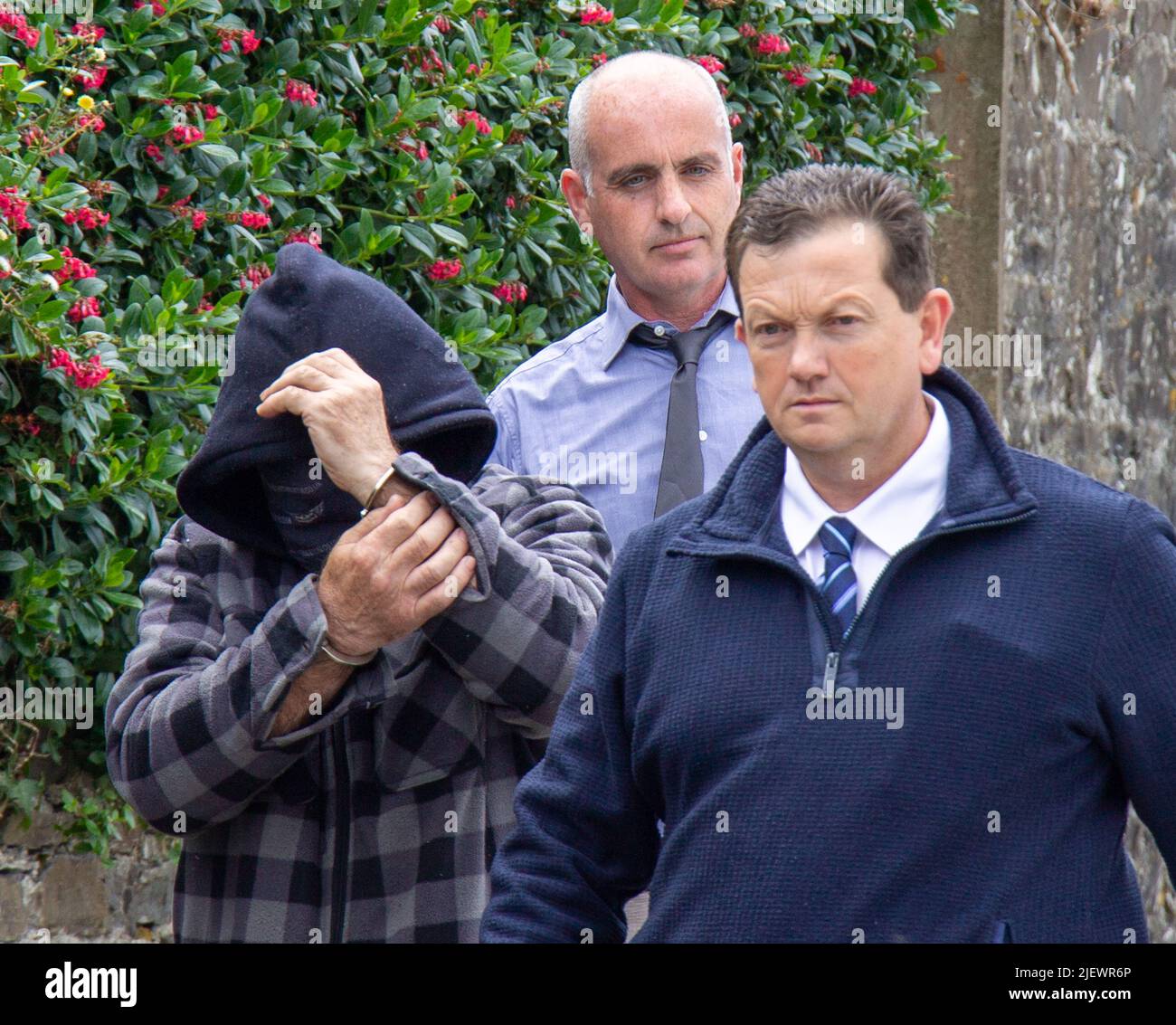 Suspect being led away from court in handcuffs Stock Photo