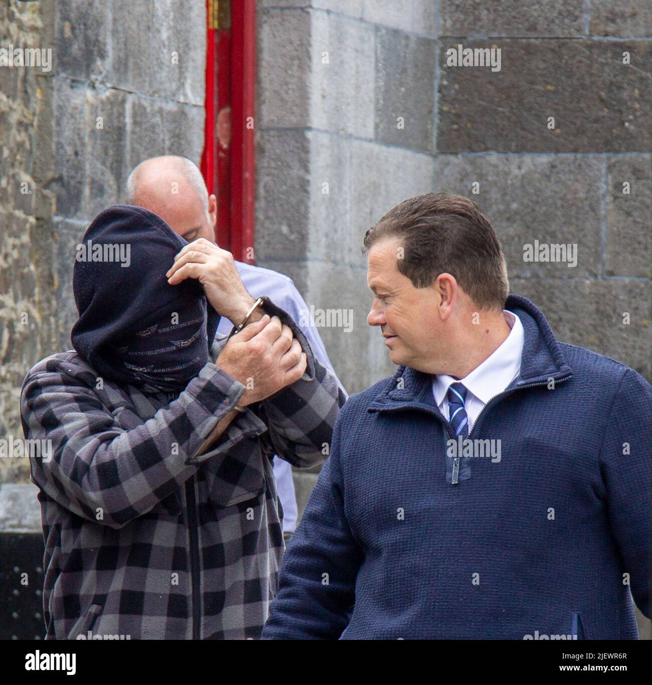 Suspect being led away from court in handcuffs Stock Photo