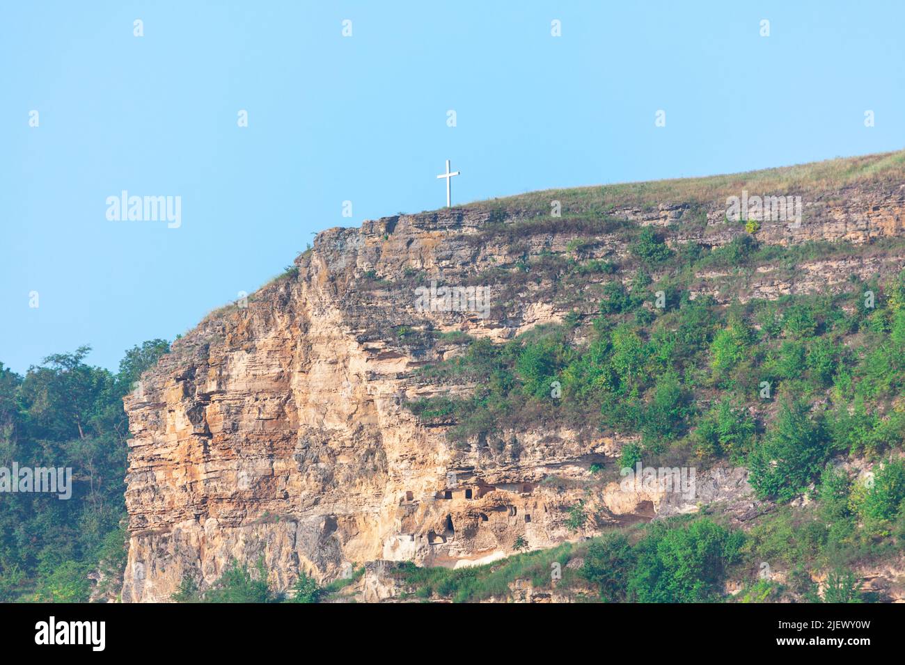 Christian Cross at the Mount Peak . Cliff scenery and rocky hill Stock Photo