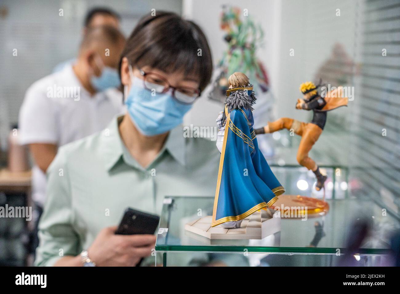 BIJIE, CHINA - JUNE 28, 2022 - Citizens view animation and cultural products at Mingyue Arts and Crafts Co., LTD., Qixingguan Economic Development Zon Stock Photo