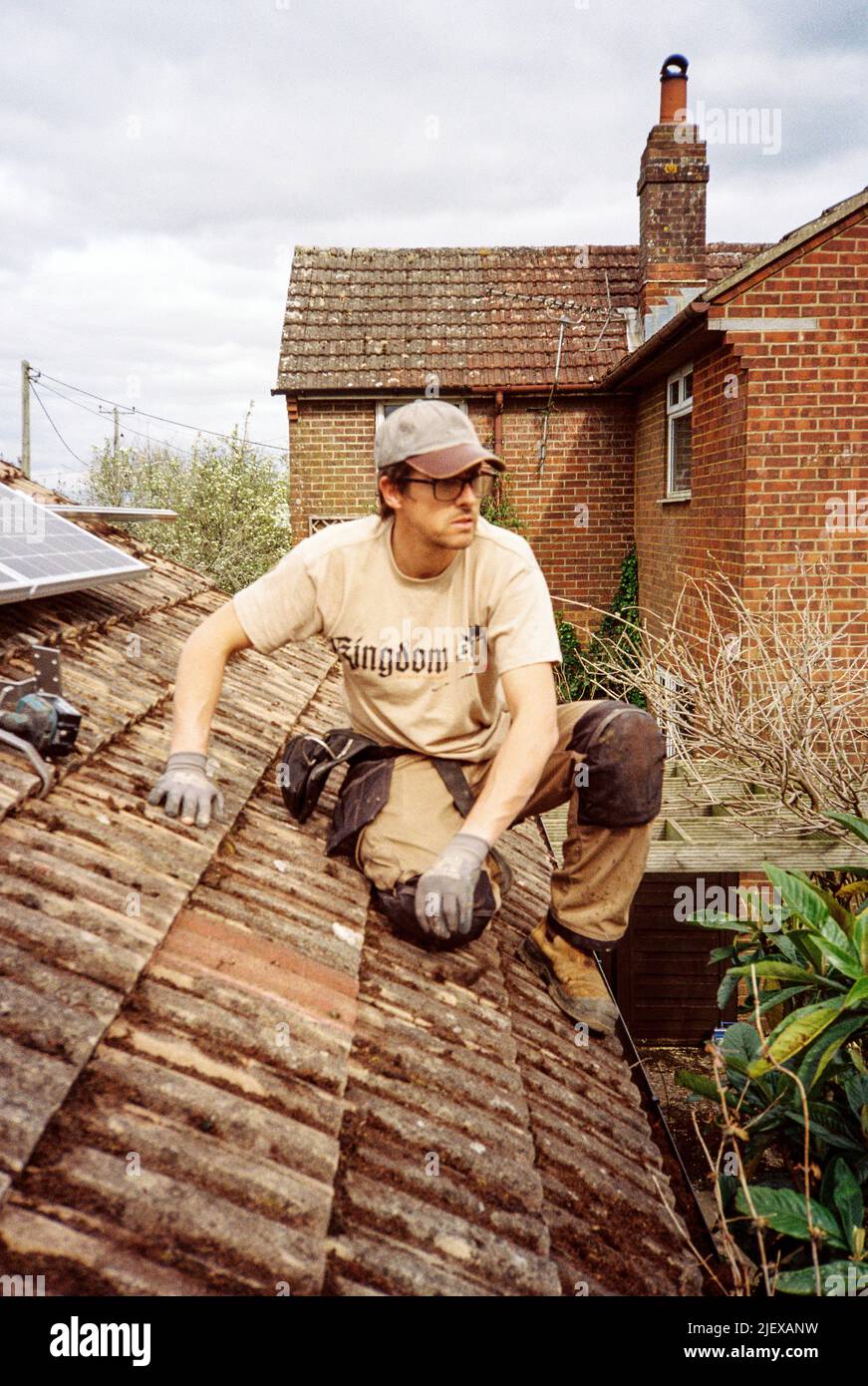 Solar panels being installed on garage roof, Hampshire, England, United