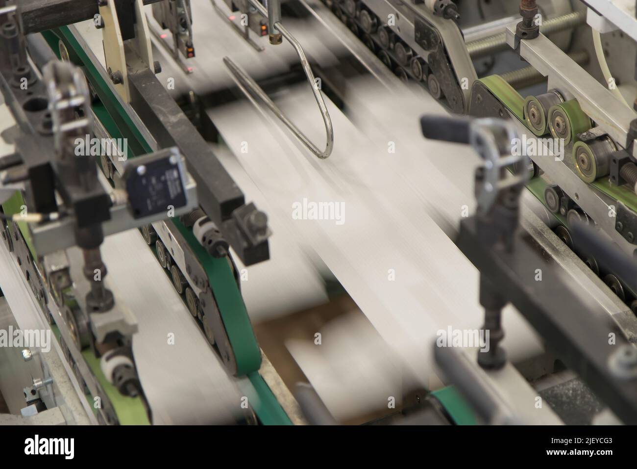 Close up detail of industrial machinery at work in a production line ...