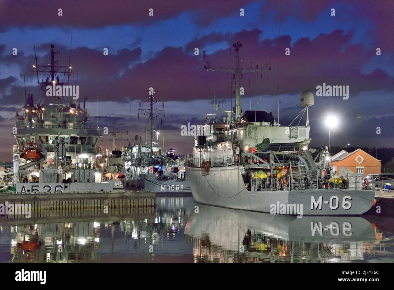 Nighttime shot of vessels of NATO's SNMCMG1  moored in the KGV Lock in London Stock Photo