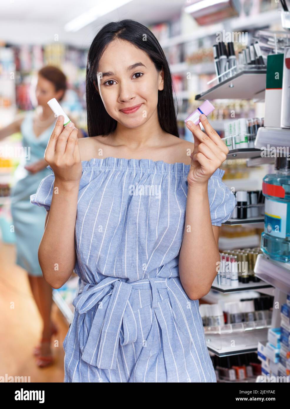 Girl testing new lipstick in cosmetics shop Stock Photo Alamy