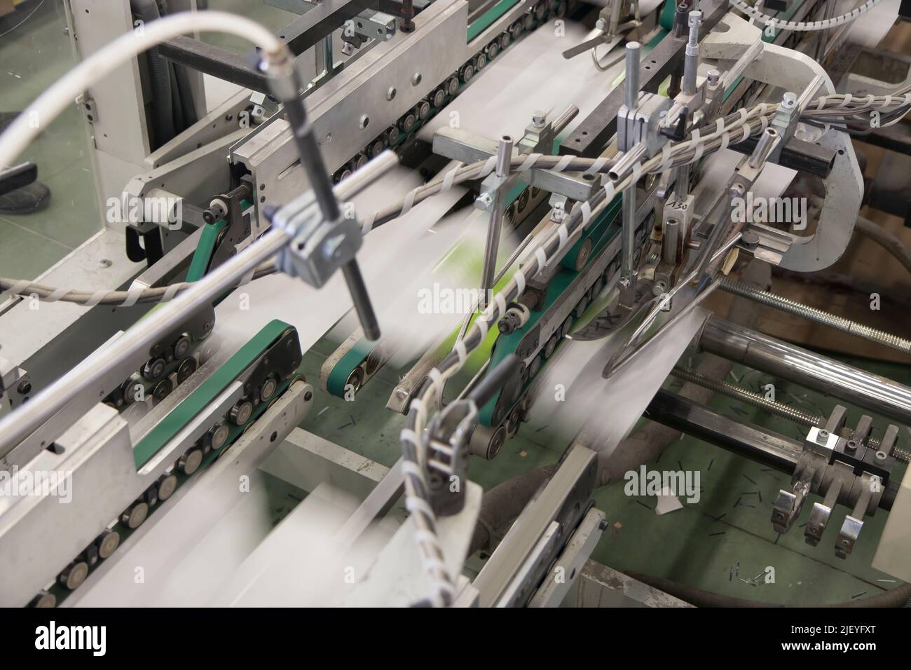 Close up detail of industrial machinery at work in a production line ...