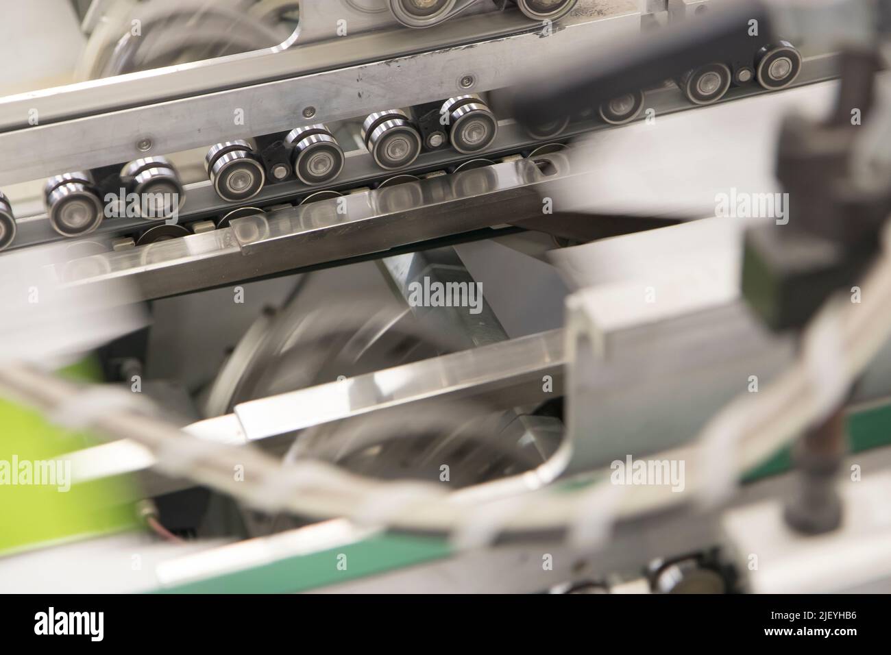 Close up detail of industrial machinery at work in a production line ...