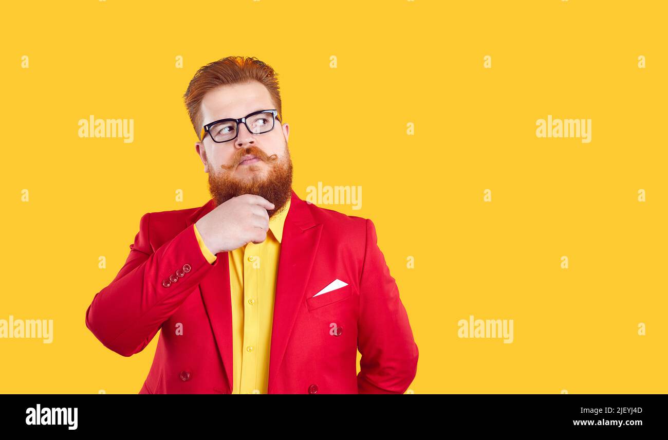 Fat bearded man in red jacket and glasses thinking and looking away at copy space Stock Photo