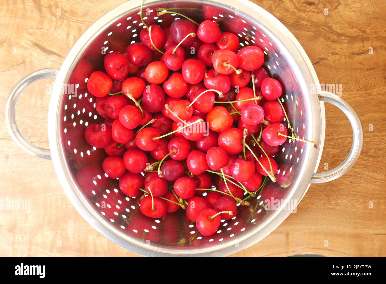 Fresh red cherries in a colander on a table, Hungary Stock Photo