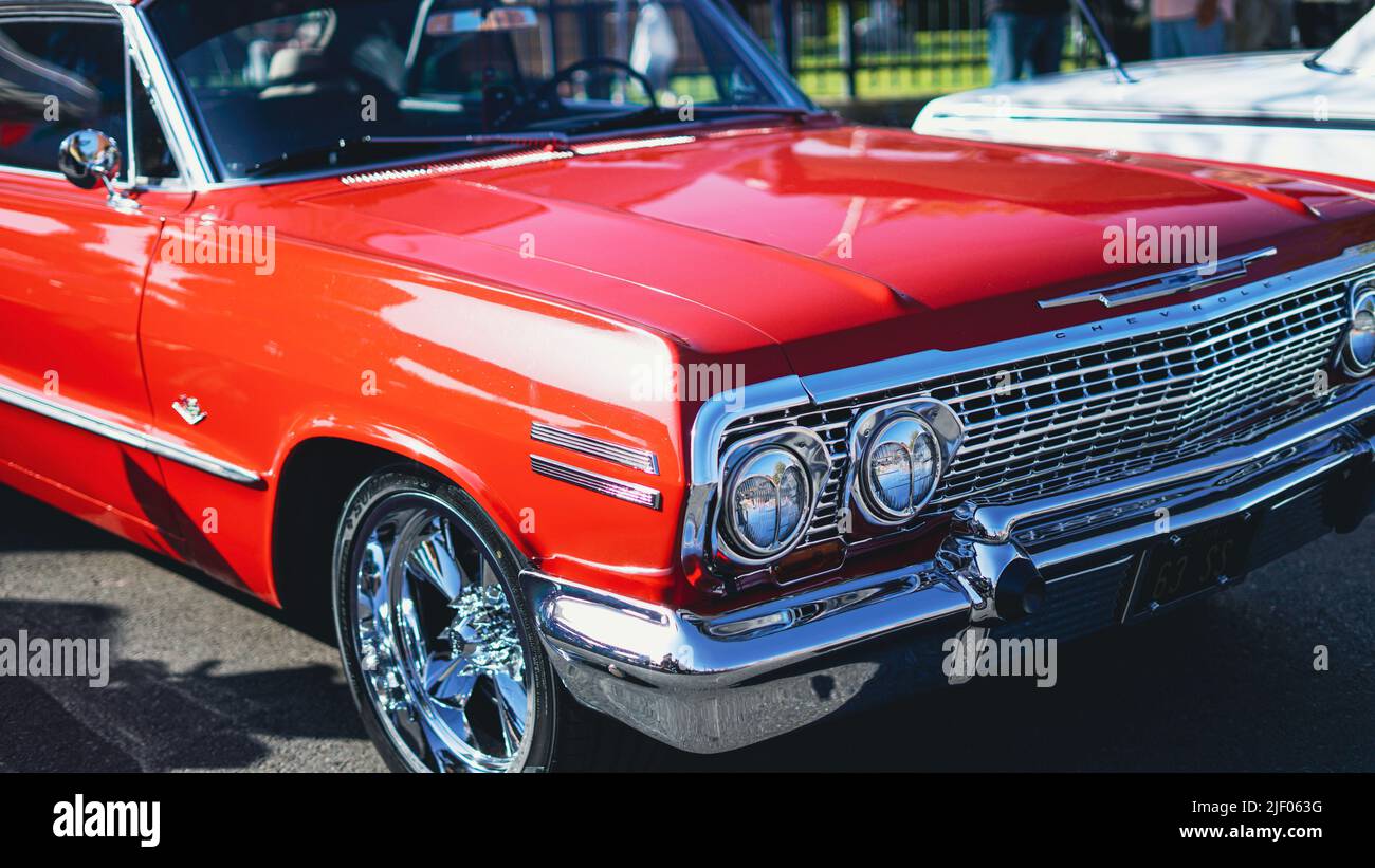 A red cabriolet Chevrolet impala in a classic car show in Santa Paula