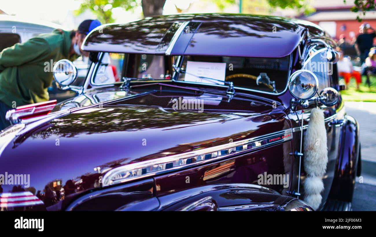 A dark shiny vintage classic car in a cars show in Santa Paula