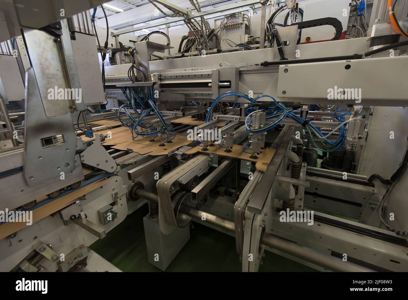 Close up detail of industrial machinery at work in a production line ...