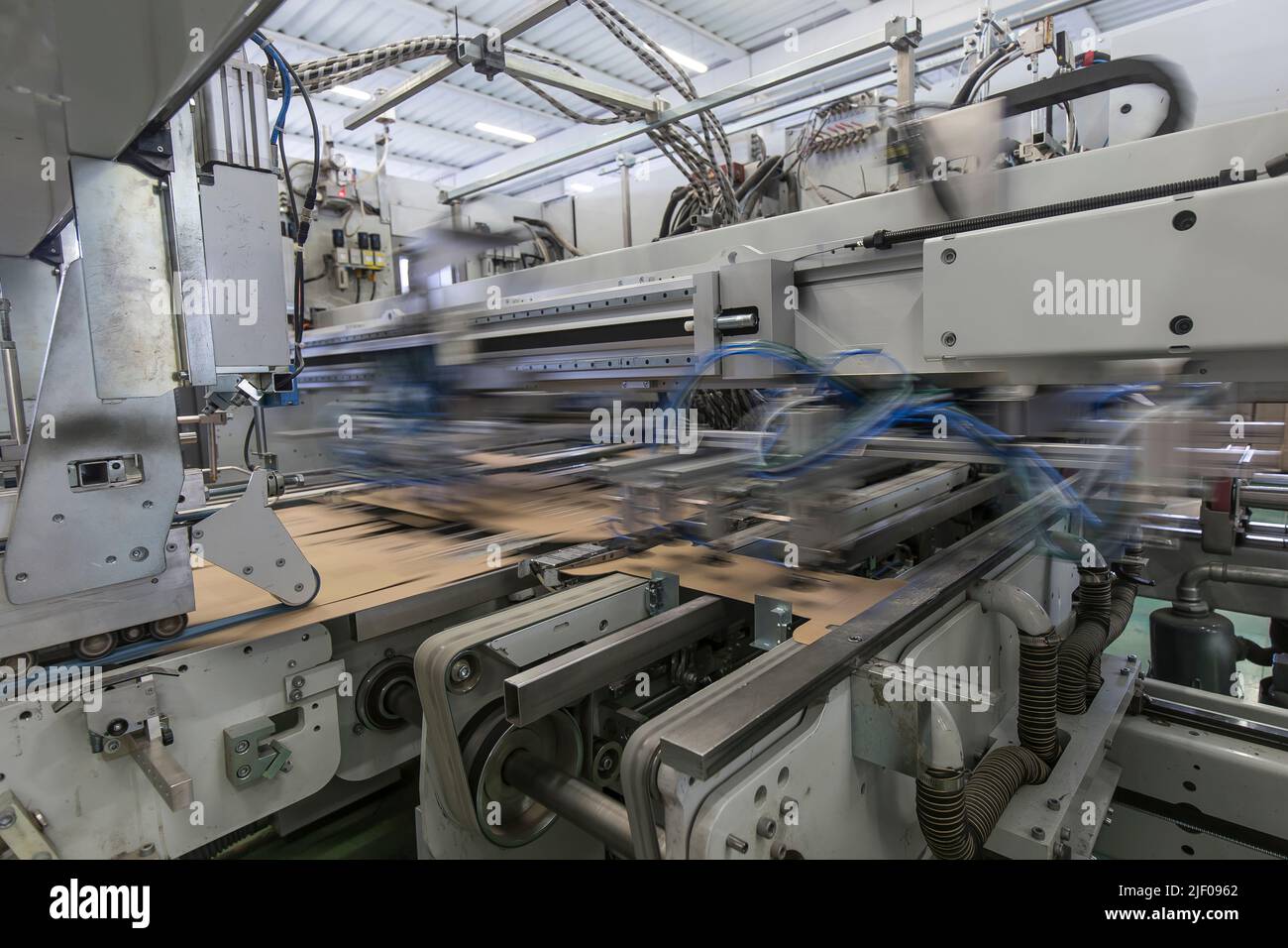 Close up detail of industrial machinery at work in a production line ...