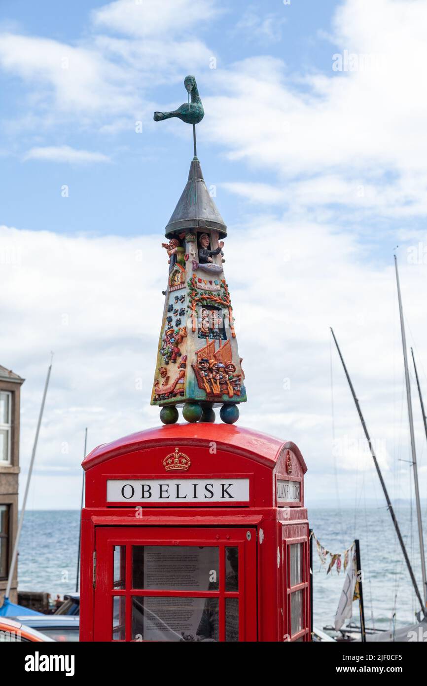 Alan Faulds artwork 'The Largo Obelisk' on top of an old red telephone box in Lower Largo, Fife, Scotland Stock Photo