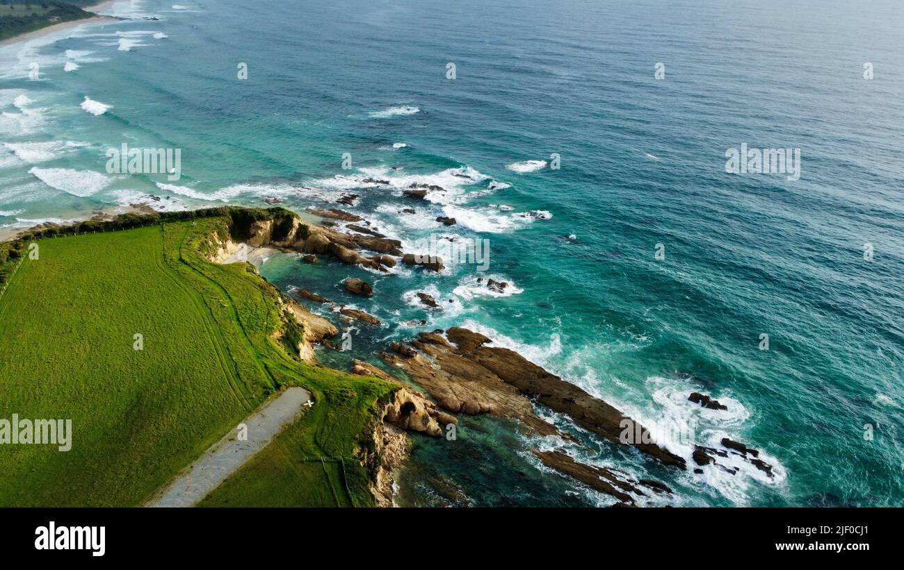 A bird's eye view of waves hitting the rocks of a beach Stock Photo - Alamy