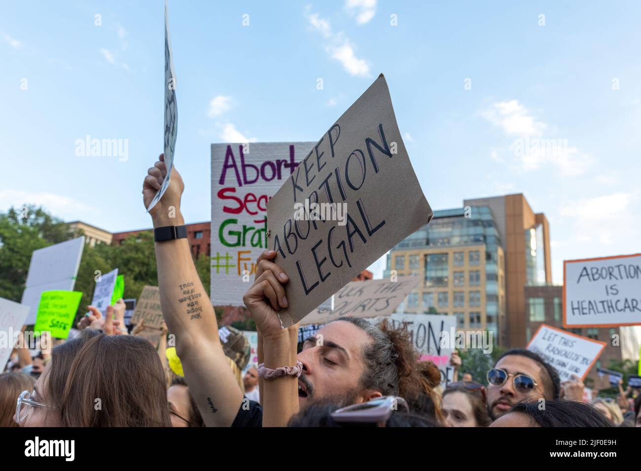 A Crowd Of Protesters Holding Cardboard Signs After The Supreme Court ...