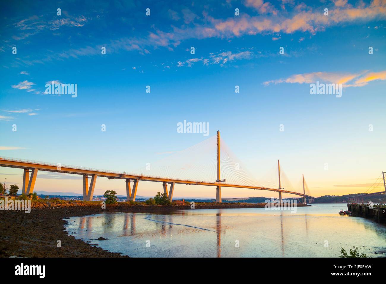 The Queensferry Crossing the new bridge over the Firth of Forth turning golden at sunrise, Edinburgh Scotland. Stock Photo