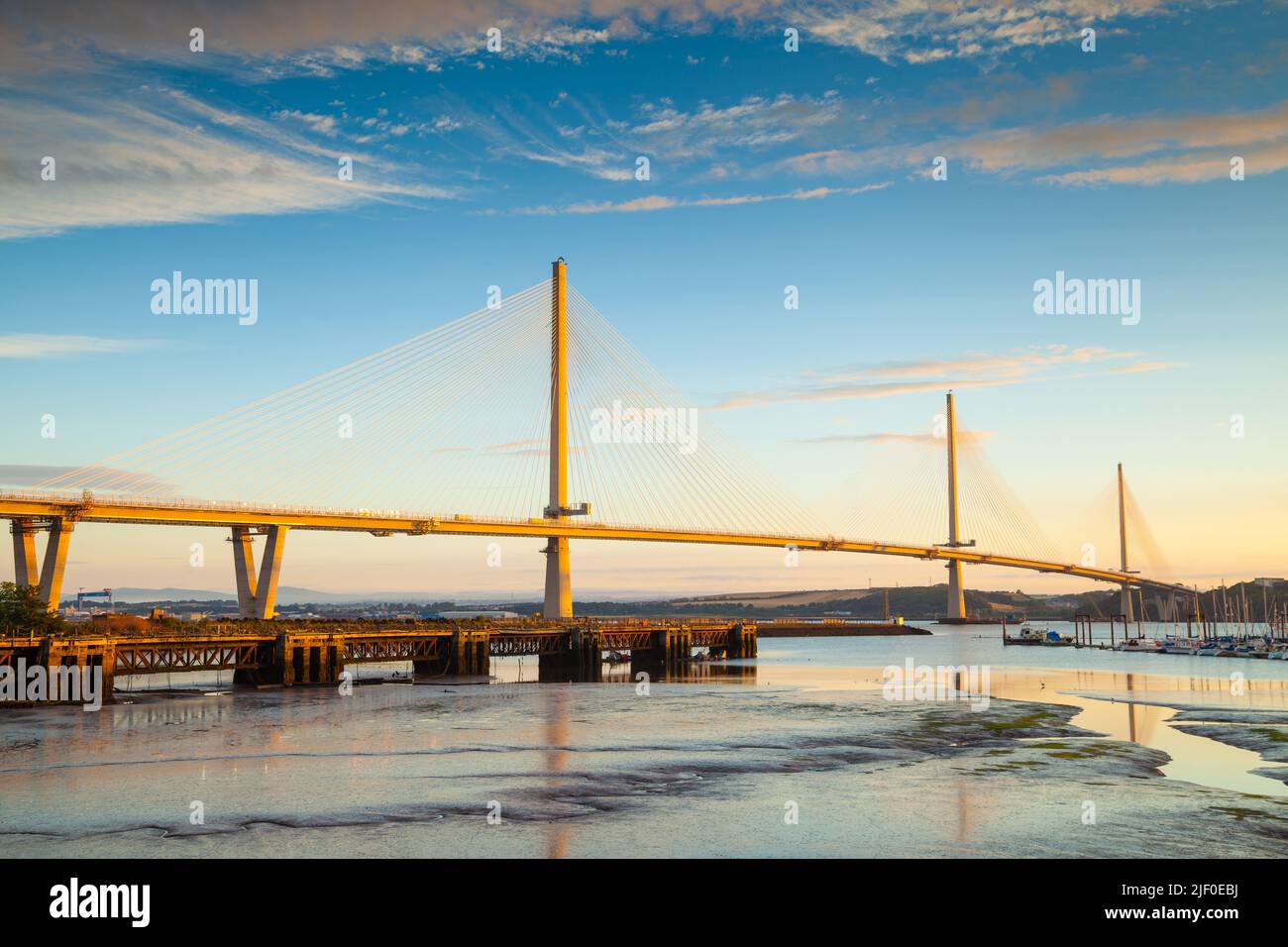 The Queensferry Crossing the new bridge over the Firth of Forth turning golden at sunrise, Edinburgh Scotland. Stock Photo