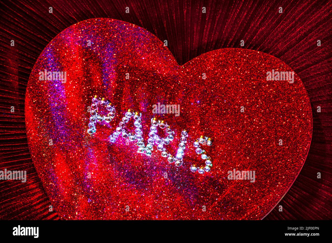 PARIS CITY LOVERS CONCEPT Sparkling jewel PARIS motif on red sparkling love heart with multicolored lighting Stock Photo
