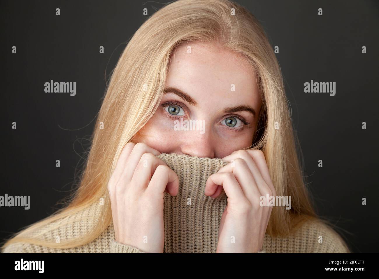 girl covering her face with sweater Stock Photo