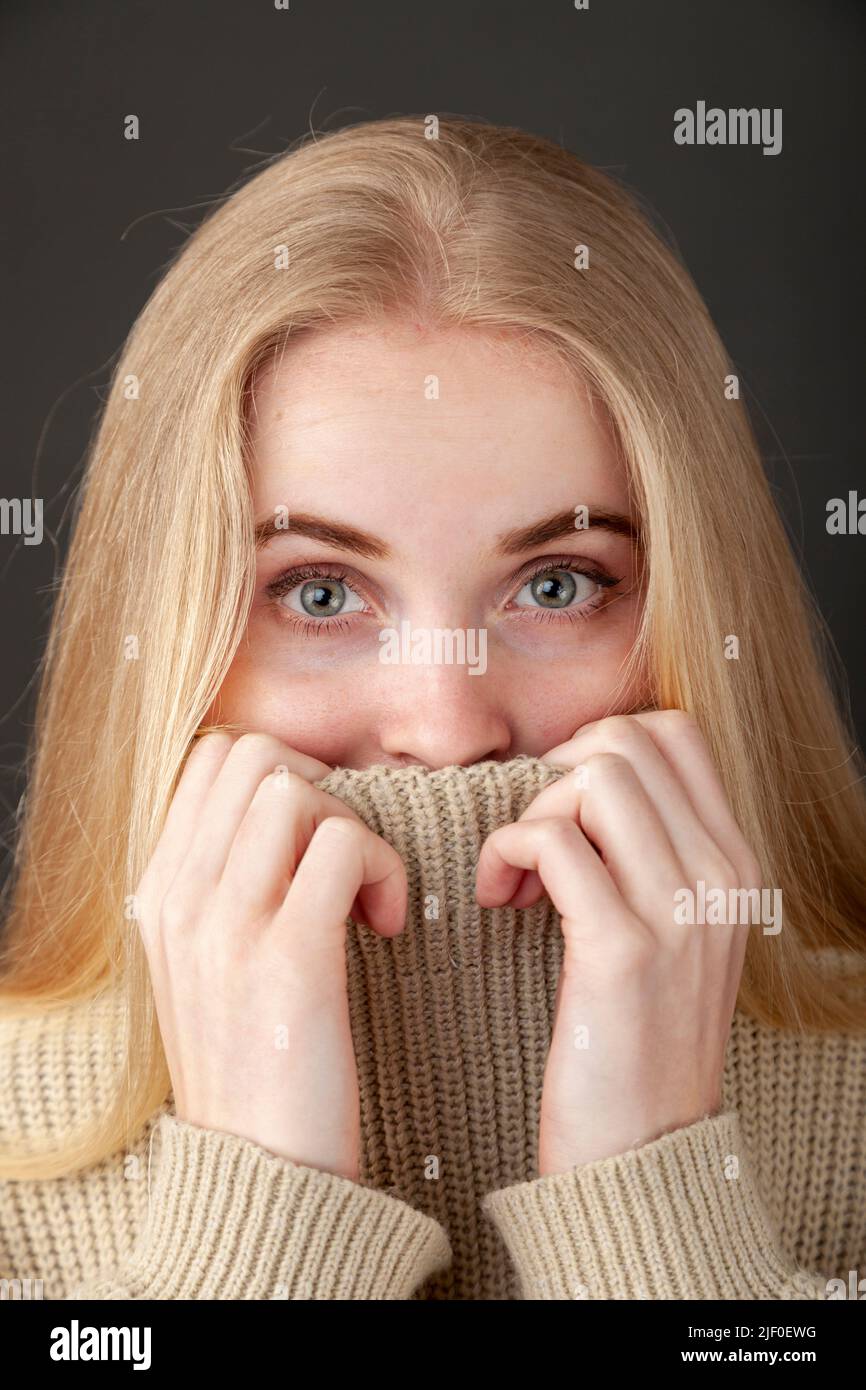girl covering her face with sweater Stock Photo