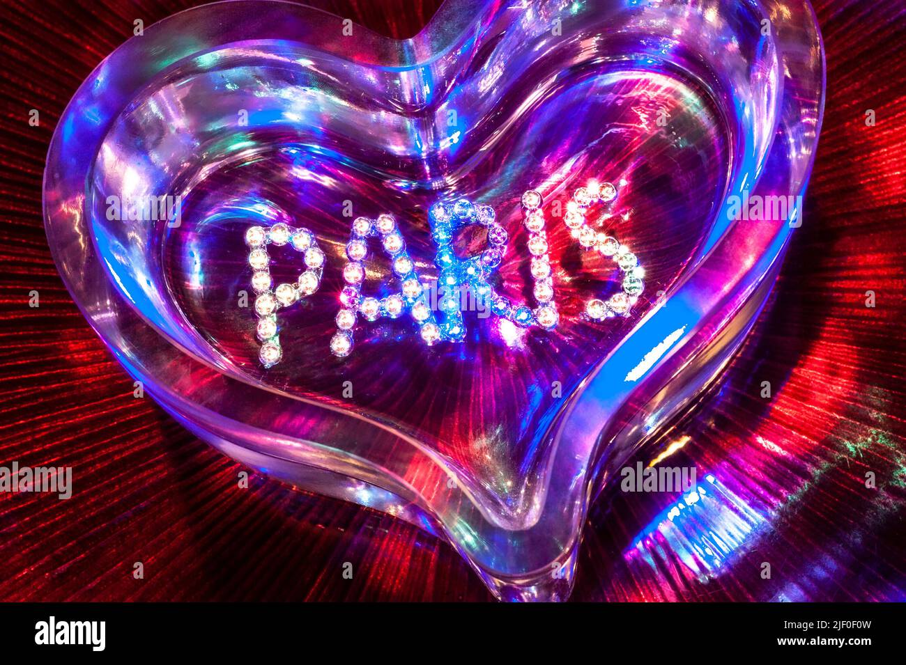 PARIS NIGHTCLUB PIGALLE SHOWTIME CABARET CLUB diamonds crystal glass heart with mixed colour lighting in fun clubbing party theatre disco show concept Stock Photo