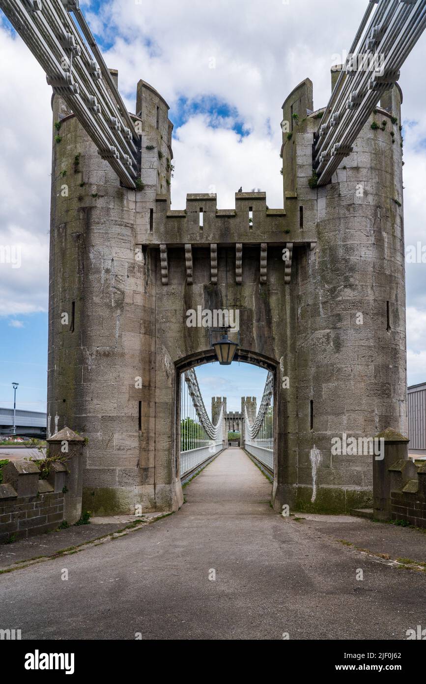 Historic Thomas Telford suspension bridge leading to the ancient castle in Conwy North Wales Stock Photo