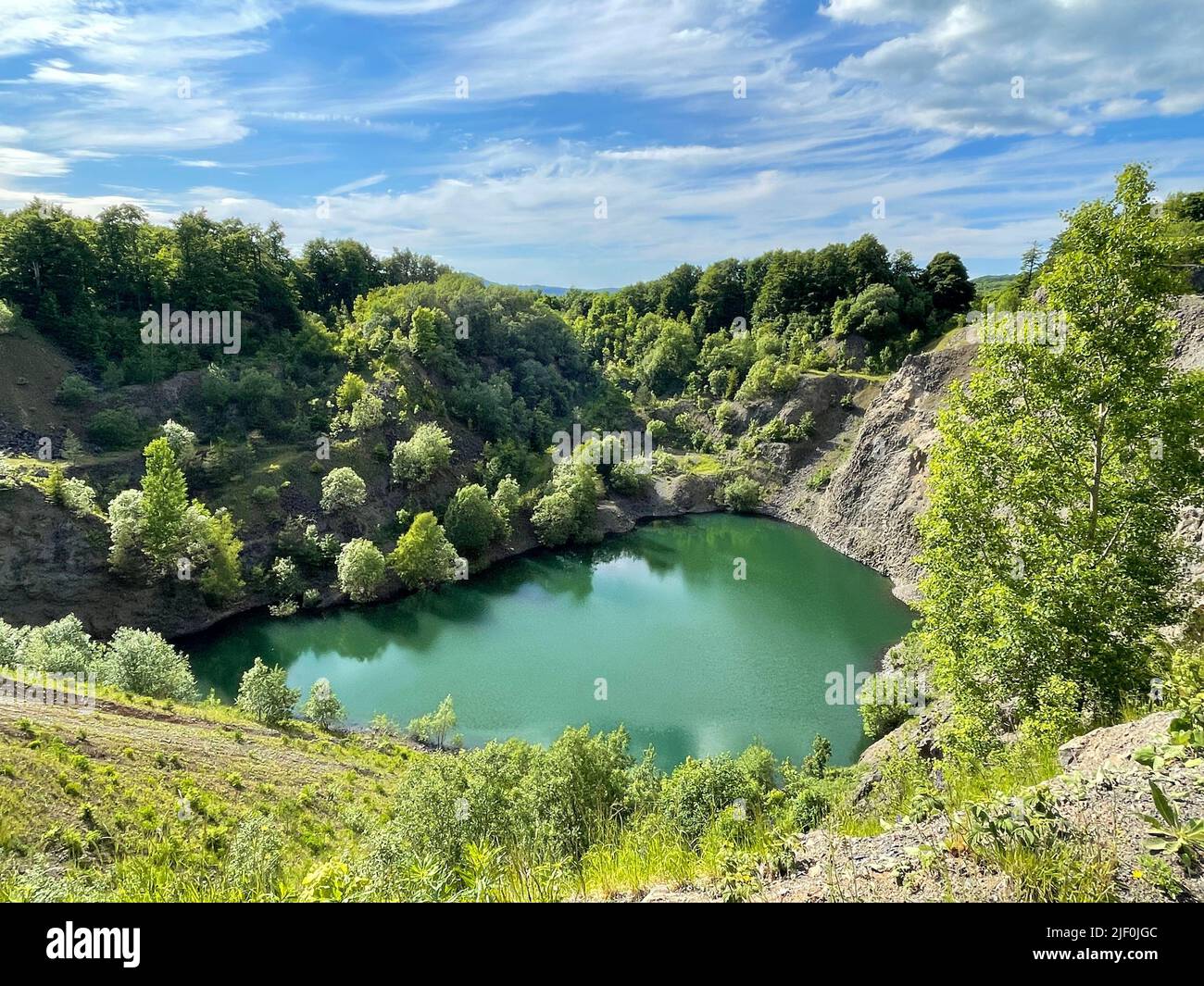 Outside Rocy A small calm lake surrounded by rocky mountains and trees Stock Photo ...