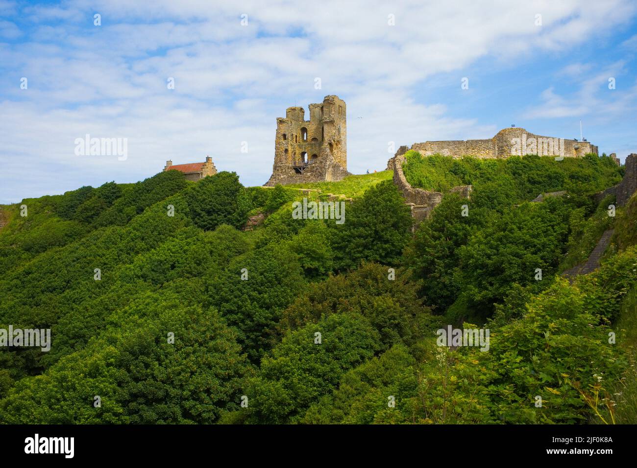 The half demolished keep of Scarborough castle overlooks the north and south bays Stock Photo