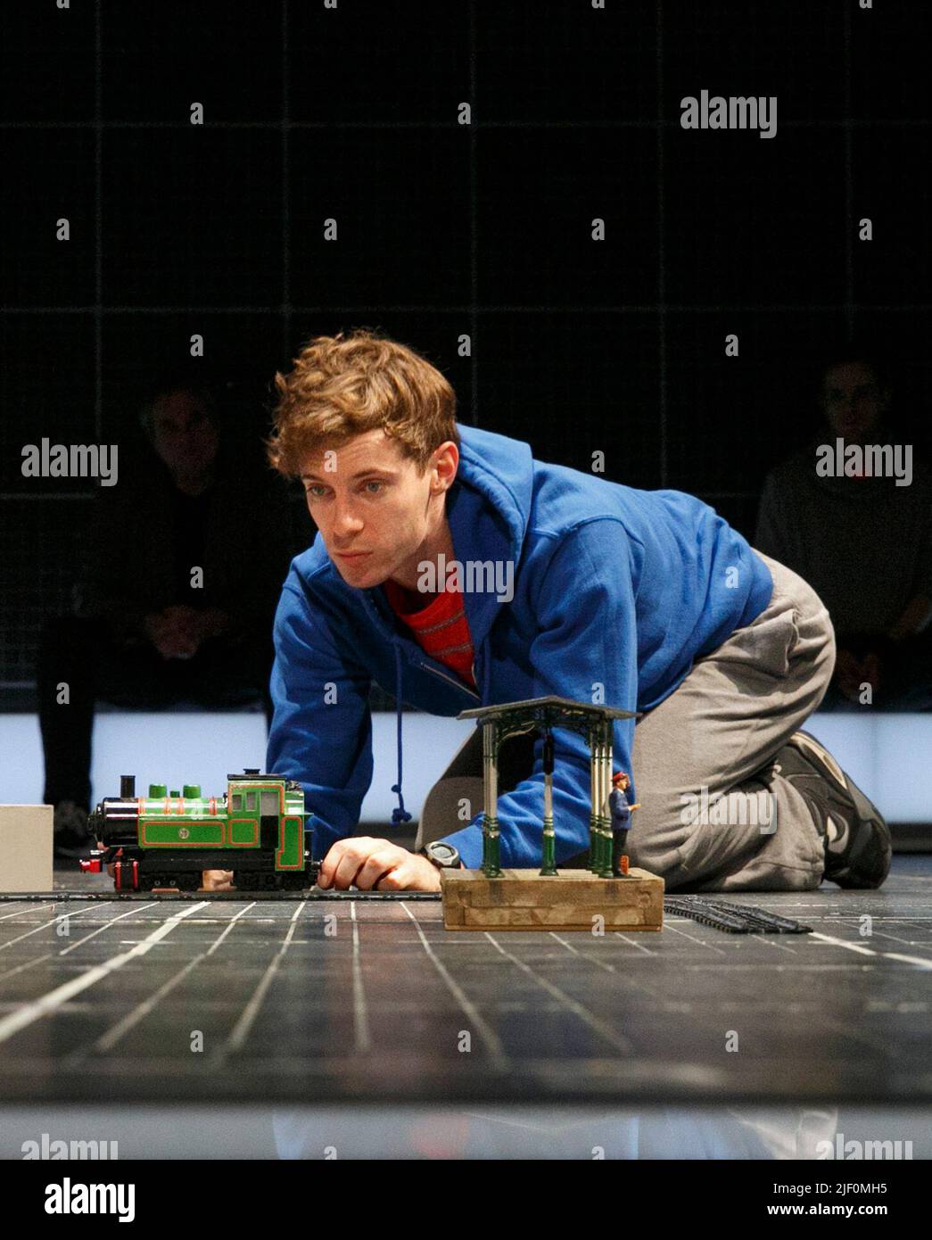 Luke Treadaway (Christopher Boone) in THE CURIOUS INCIDENT OF THE DOG IN THE NIGHT-TIME by Simon Stephens at the Apollo Theatre, London W1  12/03/2013  a National Theatre production  adapted from the novel by Mark Haddon  design: Bunny Christie  lighting: Paule Constable  video design: Finn Ross  director: Marianne Elliott Stock Photo