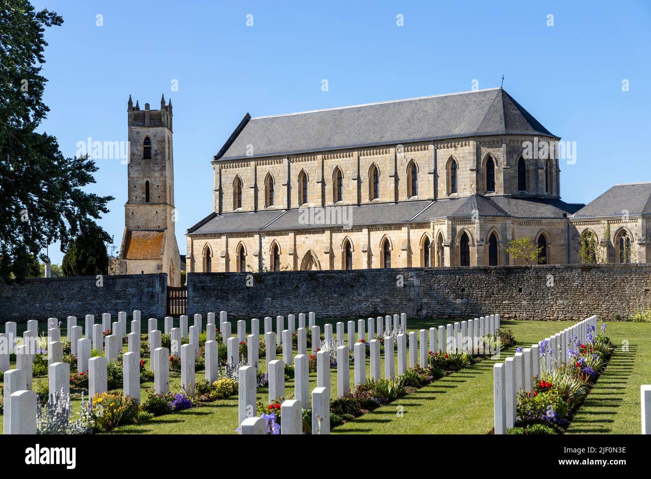 Church and war graves at Ranville British Military Cemetery Stock Photo