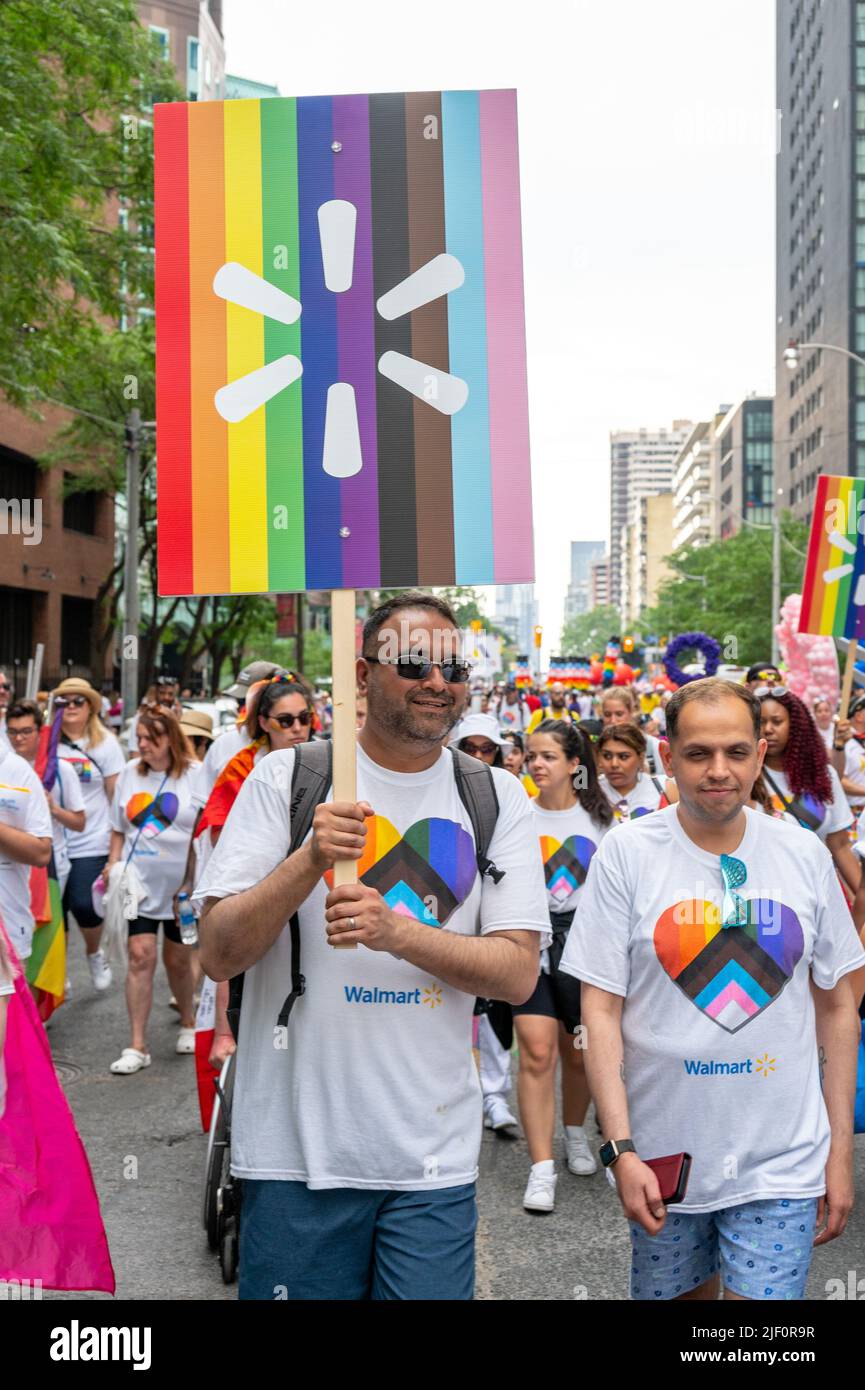 A group of people belonging to Walmart marches during Pride Parade. Stock Photo