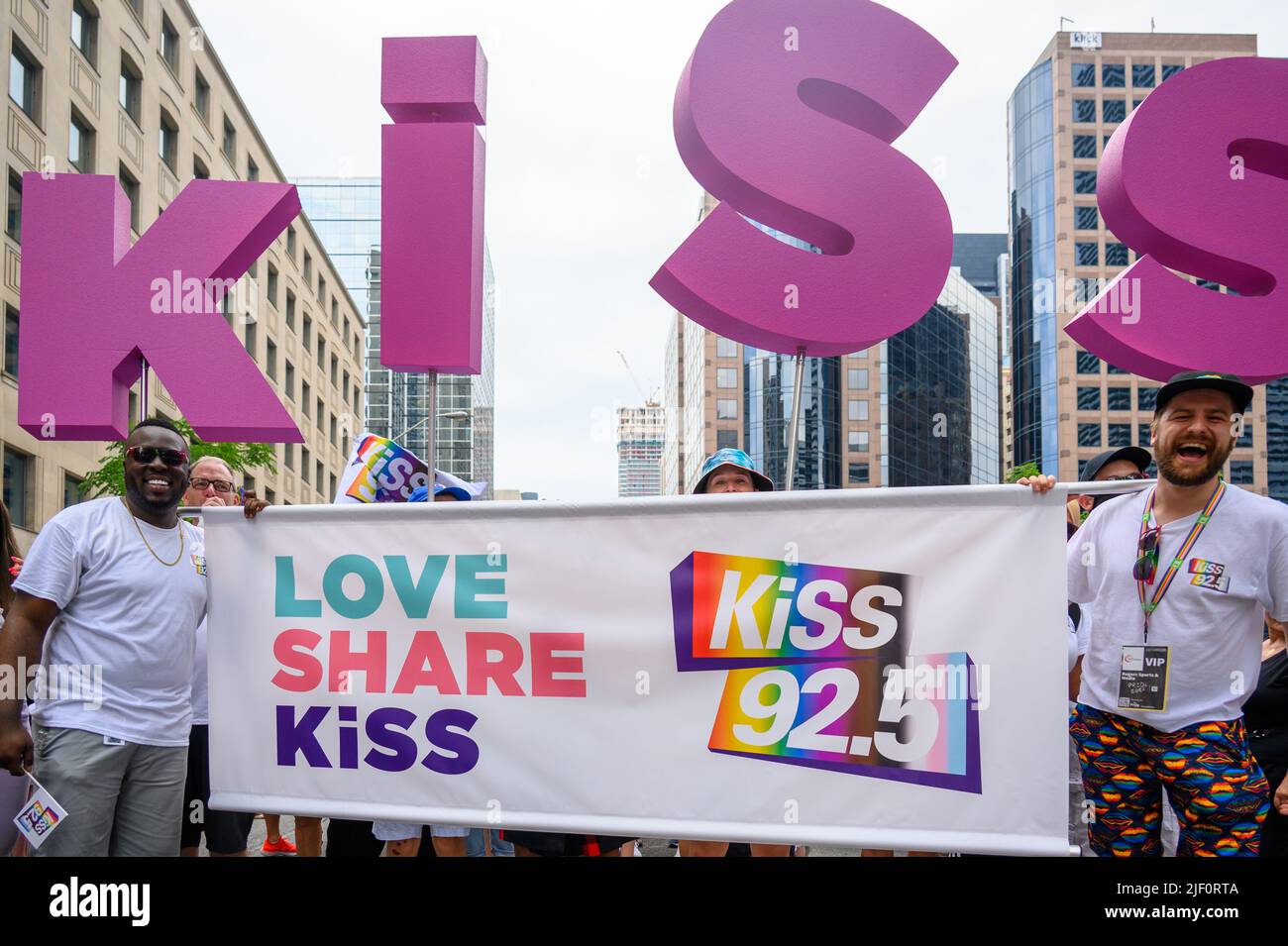 Group of people belonging to Kiss 92.5 radio station marching in Bloor
