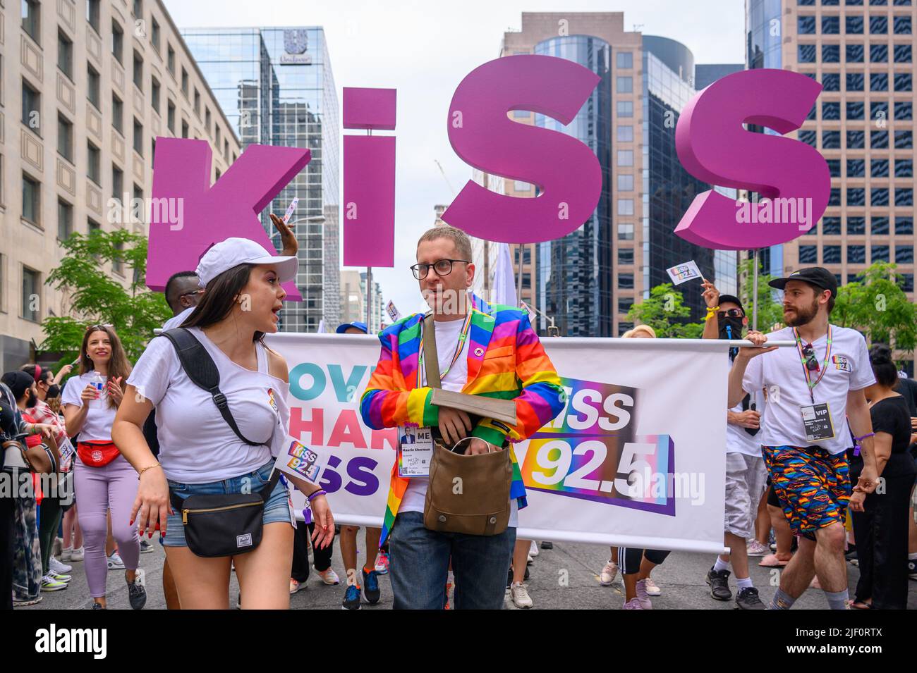 Maurie Sherman (rainbow jacket) from Kiss 92.5 radio station marches in Bloor St. during Pride Parade Stock Photo