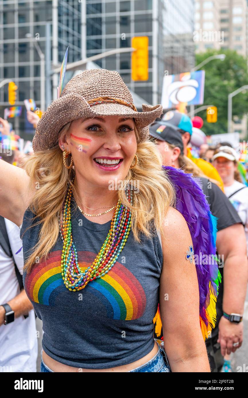 Beautiful woman smiling while marching in the Pride Parade Stock Photo