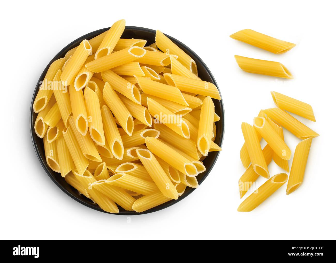 Raw italian penne rigate pasta in black bowl isolated on white background. Top view. Flat lay Stock Photo