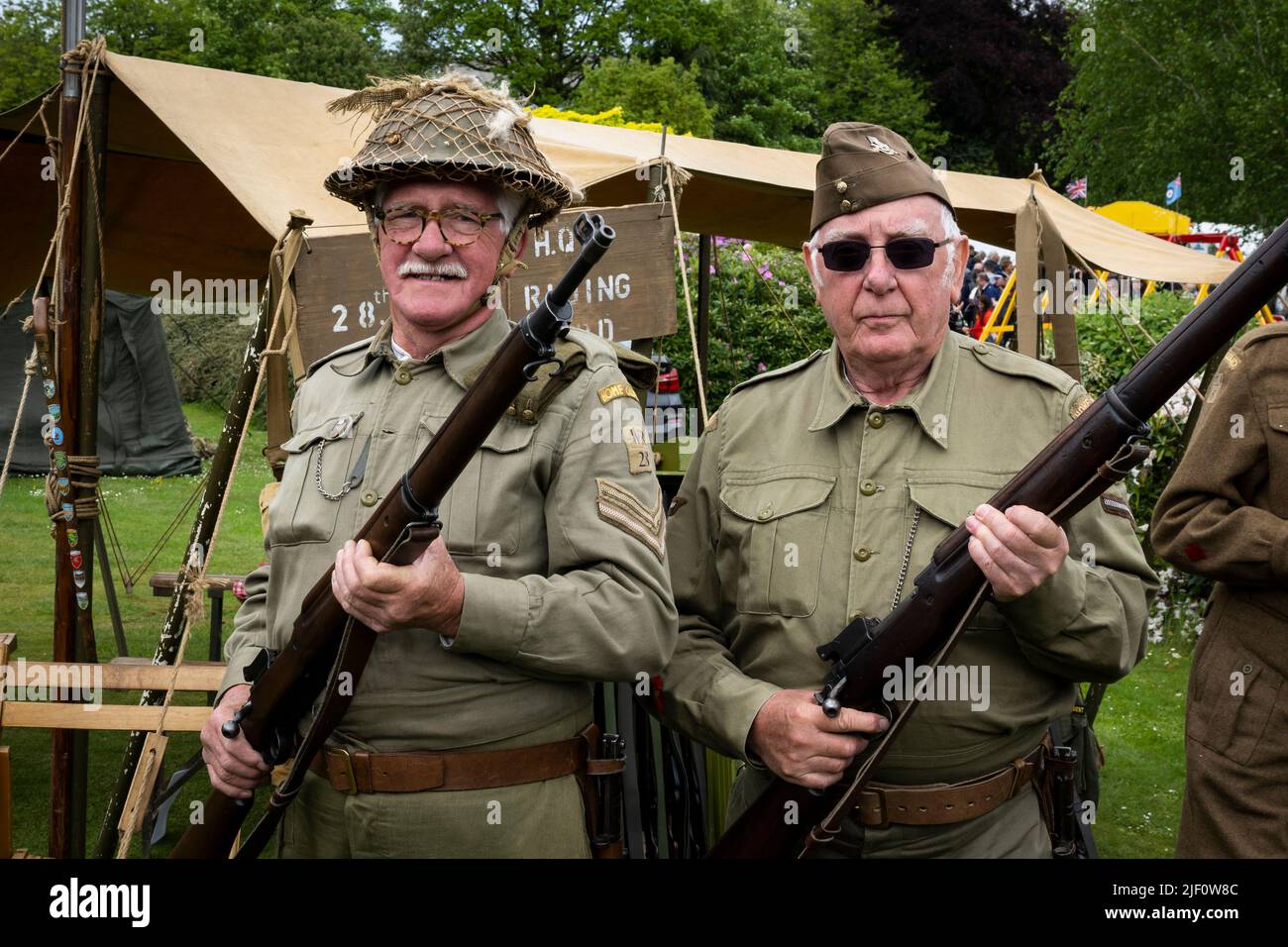 Haworth 1940's living history event (2 men on guard duty, dressed in khaki WW2 Dad's Army costume, encampment & HQ tent) - West Yorkshire, England UK. Stock Photo