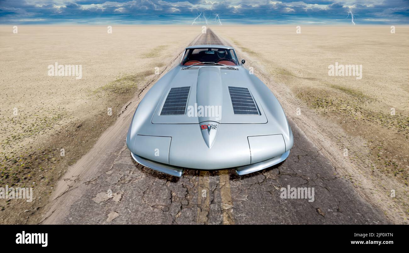 Old classic corvette 1963 sports car in a desert road, wide angle front view. Stock Photo