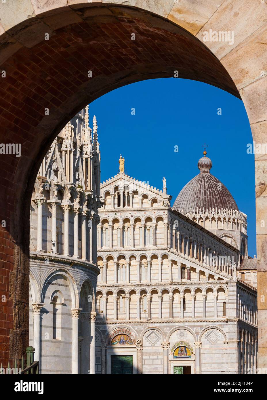 Pisa bastistry and Cathedral in the Square of Miracles, seen through ancient city walls gate Stock Photo