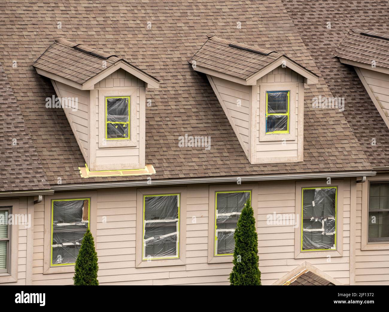 Masking tape holding plastic covering in place on windows prior to