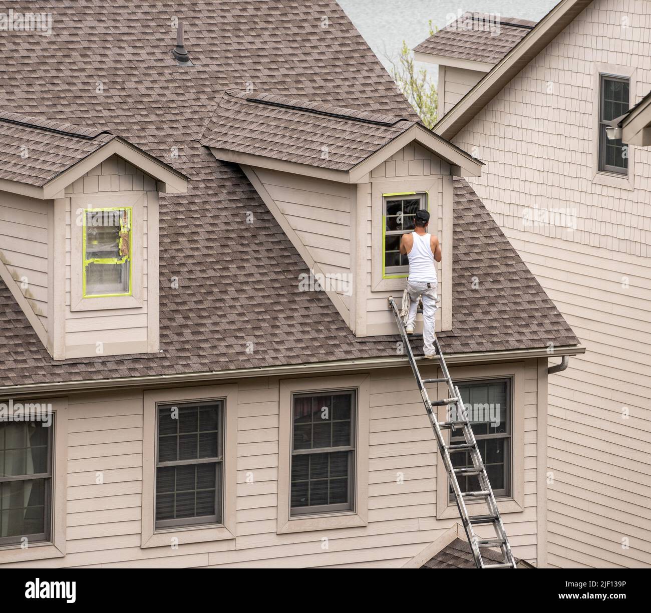 Masking tape holding plastic covering in place on windows prior to