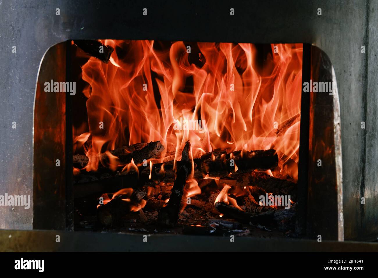 Fire flames from a wood stove fire isolated on a black background Stock