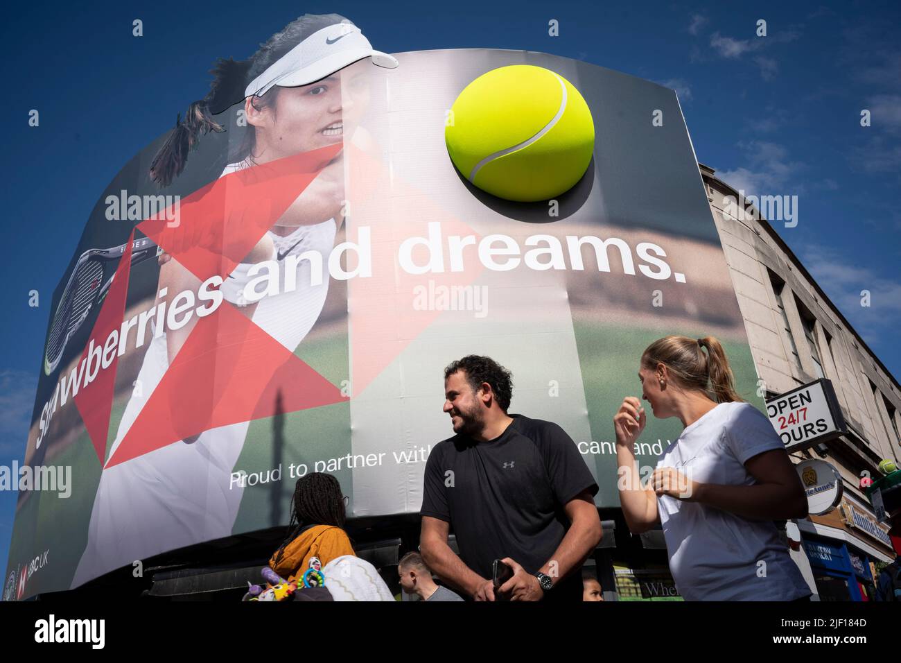 British tennis player, Emma Raducanu appears on a giant billboard in Wimbledon town centre, on the first day of competition during the Wimbledon Lawn Tennis Association championships, on 27th June 2022, in London, England. Stock Photo