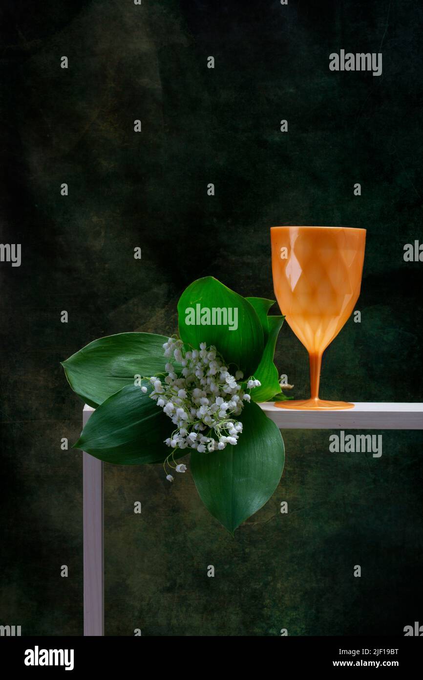 Still life with a bouquet of lilies of the valley and a glass Stock ...