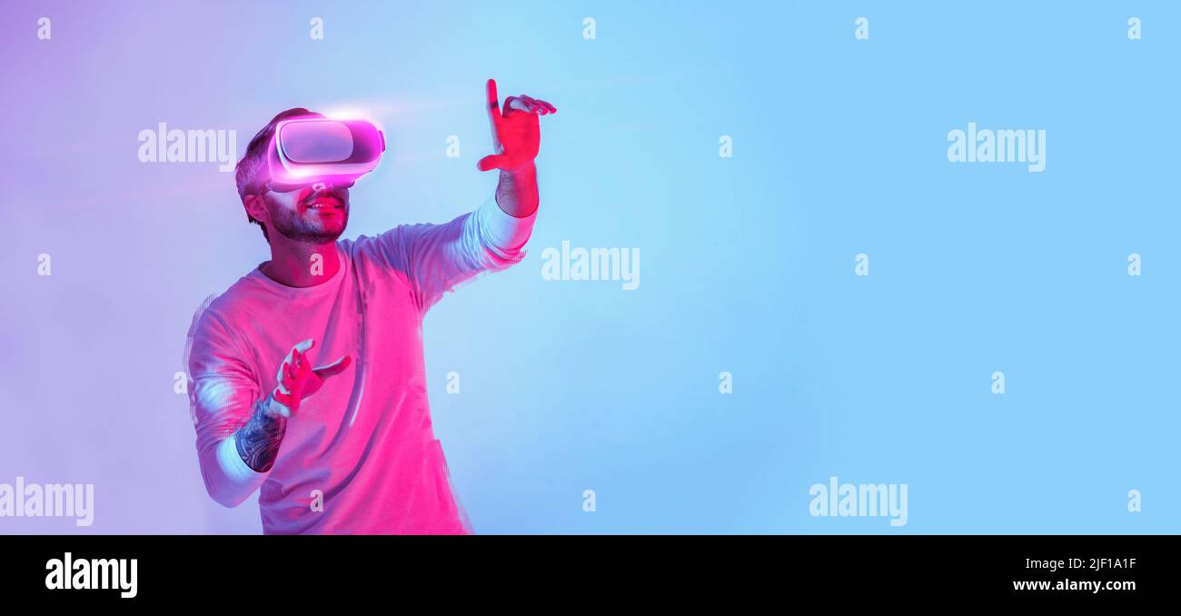 Guy in virtual reality glasses touching empty space Stock Photo