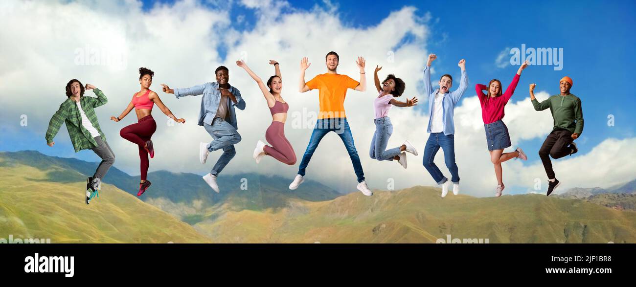 Group Of Happy Multiethnic Men And Women Jumping On Mountains Landscape Background Stock Photo