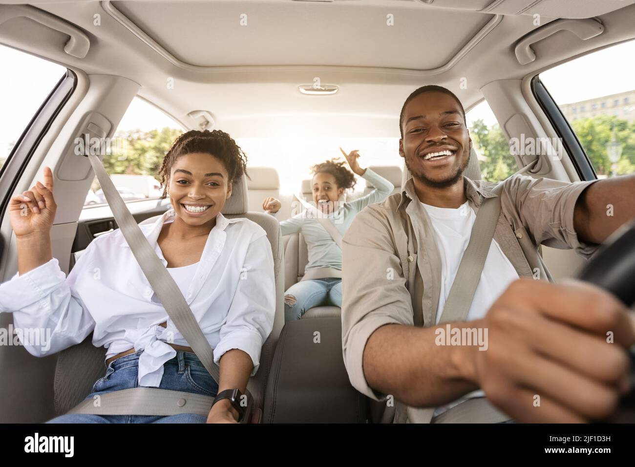 Black Family Riding Car Traveling In Summer, Smiling To Camera Stock Photo